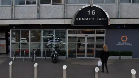 Google Maps General view of the West Midlands Combine Authority's headquarters. It shows a building with a row of glass window and a glass door with a black sign over head that reads 16 Summer Lane. On the right is a orange hexagon logo above the words West Midlands Combined Authority.
