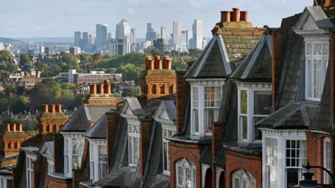 A general view of late Victorian and Edwardian red brick terraced houses on a street in Muswell Hill.