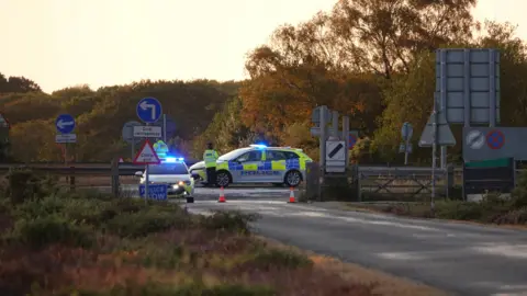 Police cars preventing cars from entering the A31.