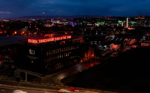 Dougie Lindsay/MEC, studios Drone picture of the sign with Glasgow’s skyline in the background. You can see the science centre tower, BBC Scotland, the Hydro and Glasgow University.