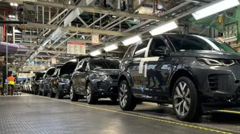 Black cars on a production line at Jaguar Land Rover's Halewood factory