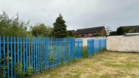 A long blue fence