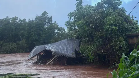Honolulu Fire Department A building collapsed in high muddy floodwaters