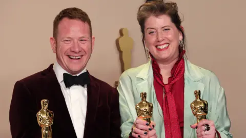 Reuters James Price and Shona Heath holding their Oscars