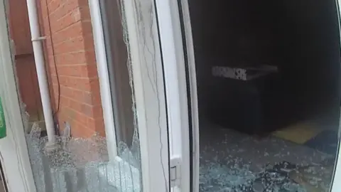 Nottinghamshire Police Bodycam image of a patio door, which has had the glass smashed