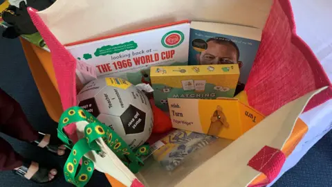 Picture of one of the memory bags including a football and books