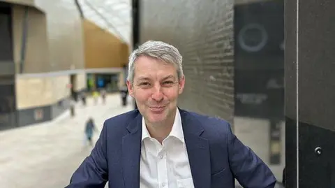 Will Forster Will Forster, wearing a blue jacket and a white shirt, poses for a picture in the main foyer of the British Museum in London.