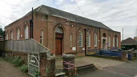 Google Streetview image of a red brick building, which is Charminster Library