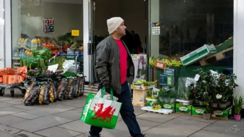 Getty Images Shopper holding a bag with Welsh flag