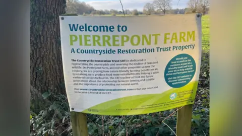 Adrian Harms/BBC A sign welcoming visitors to Pierrepont Farm in Frensham, Surrey. The sign displays information about the Countryside Regeneration Trust, an organisation dedicted to 'regenerating the countryside and reversing the decline of farmland wildlife'.