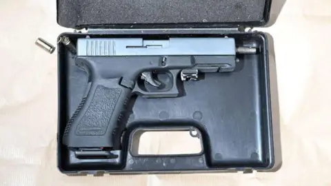 North Yorkshire Police A semi‑automatic handgun rests inside an open black plastic case with a foam‑lined lid.