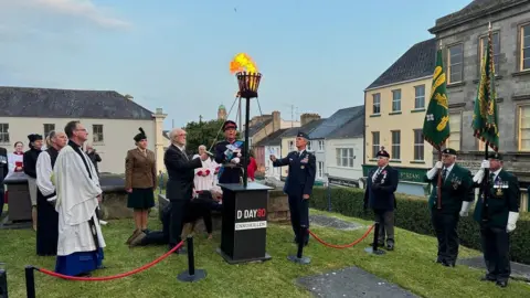 People lighting a beacon