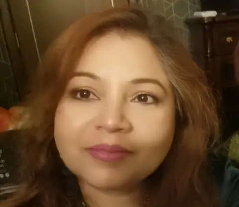 Dr Manisha Maganji  Woman with brown hair 