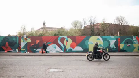 A digital mural in Piccadilly, York, showcasing the River Foss' historic influence in York with images of swans, ducks, boats and buildings. 