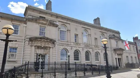 Rotherham Council building flying the flag of St George (right).