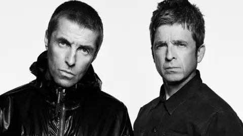 PA Media A black and white image of Liam and Noel Gallagher. Liam has closely cropped hair and wears a zipped up jacket and Noel has short hair and wars a denim jacket