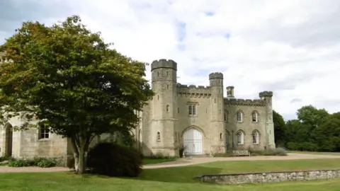 Marathon/Geograph Chiddingstone Castle. There is a tree and grass in front of it