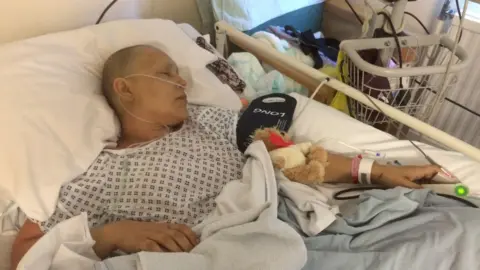 Elia Shaw Elia Shaw in bed having cancer treatment