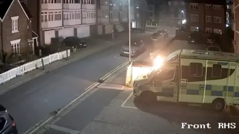 An ambulance after being set on fire