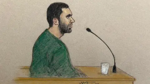 Sketch of Marcus Monzo, who is pictured sitting in the dock of the Old Bailey, behind a microphone, wearing a green jumper.