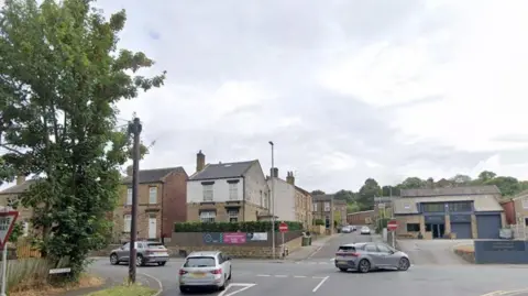 Google A shot of the junction between Church Lane and Bradford Road in Birstall - a T-junction with no entry signs flanking the road opposite and cars pulling out in both directions onto Bradford Road.