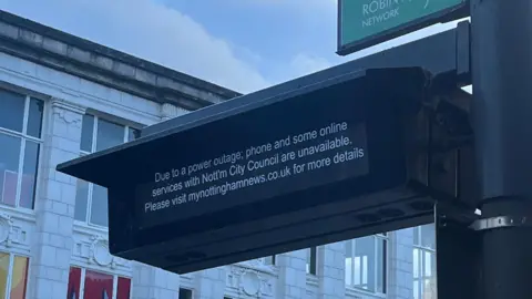 BBC A bus station sign warning of disruption to council services