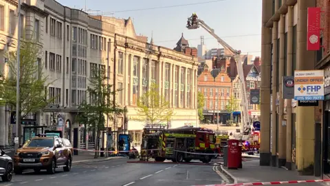 An aerial ladder vehicle in attendance at a fire