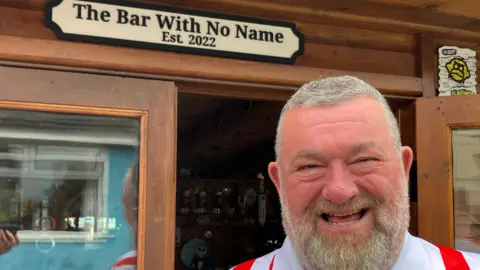 BBC Sean Ruane pictured next to his shed/bar