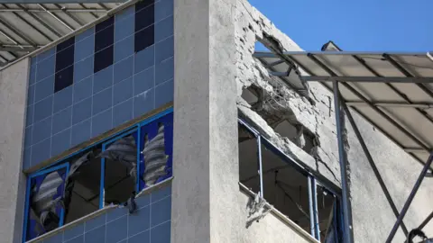 Reuters Damaged top floor of a building at al-Ahli hospital in Gaza City, northern Gaza (29 December 2024)