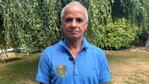 A golfer in a blue polo neck