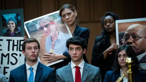 Relatives of Boeing Co. airplane crash victims hold images prior to a Senate Homeland Security and Governmental Affairs Permanent Subcommittee on Investigations hearing in Washington, DC, US, on Tuesday, June 18, 2024.