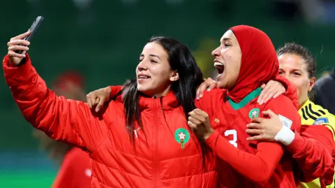 Reuters Morocco's Nouhaila Benzina celebrates after the match as Morocco qualify for the knockout stages of the World Cup