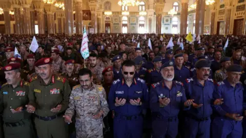 Reuters Army officers affiliated to the Houthis wearing military gear take part in the ceremony