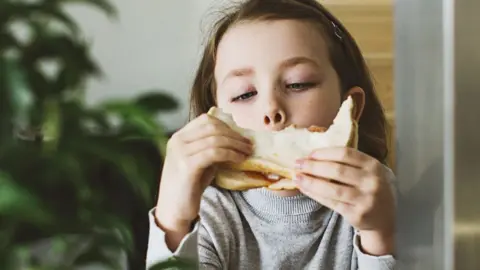 girl eating white bread