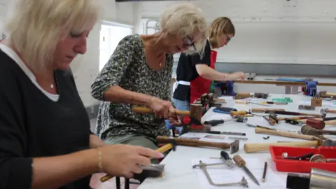 New Brewery Arts Three women making steel bangles in a workshop