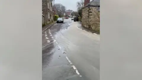 Water coming down Church Street in Fritchely