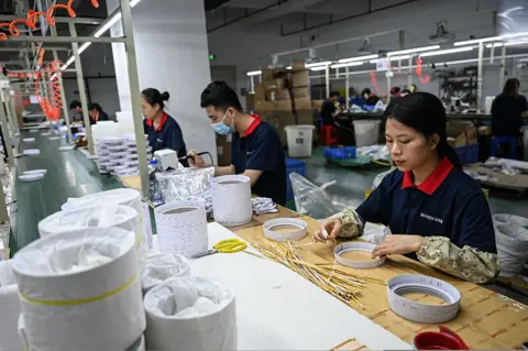 A woman working on a production line for LED lighting in Zhongshan, in southern China's Guangdong province.