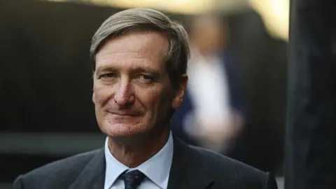 Getty Images Dominic Grieve waits to speak at an anti-Brexit demonstration organised by the People's Vote campaign near the Houses of Parliament in London in September 2019