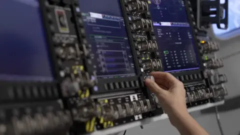 We see an astronaut training in a mission simulator.