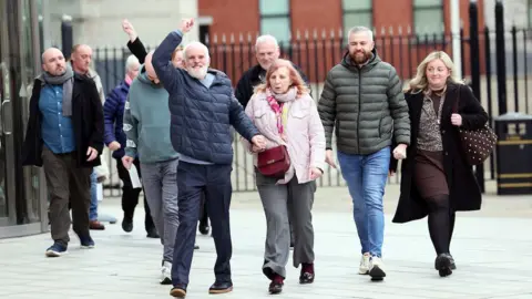 Pacemaker Press A group of people walk out of the courts of justice. 