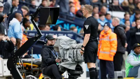 PA Media Referee Craig Pawson views the VAR screen at a football stadium