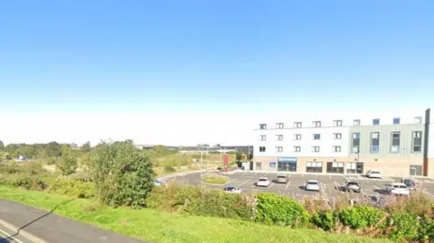 A general view of the area where the retirement flats could be built in Workington. The scrap land is off Church Street, next to a Travelodge with car parking.