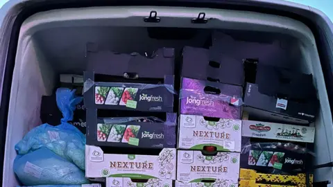 Towcester Community Larder Food in crates in the back of a van