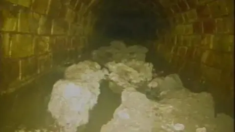 A blockage believed to weigh around 100 tonnes which has been discovered in the sewers in Whitechapel, east London. Lumps of a white fatty substance sits at the bottom of a bricked tunnel