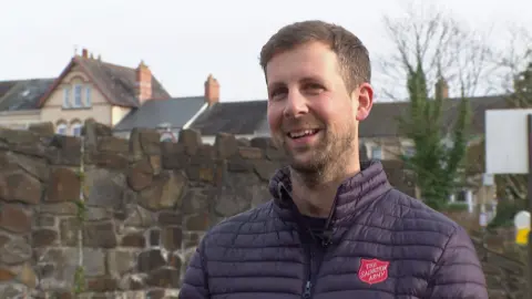 Captain Mark Read, who runs the Salvation Army in North Devon smiling while standing outside