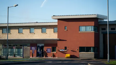 The image shows a general view of HMP Bronzefield in Ashford, Surrey.