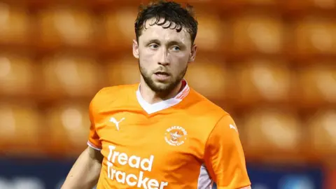 Matthew Pennington playing for Blackpool