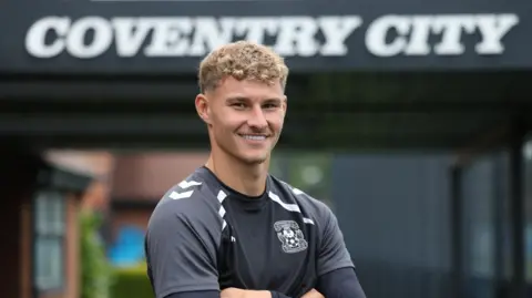 Coventry City FC Carl Rushworth stands in front of the Sky Blue Lodge at Coventry City's training ground at Ryton,