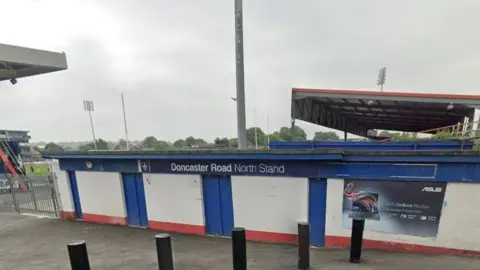 Google Streetview Wakefield Trinity's North Stand at the Doncaster Road end of the rugby league ground, with bollards and red, white and blue paintwork