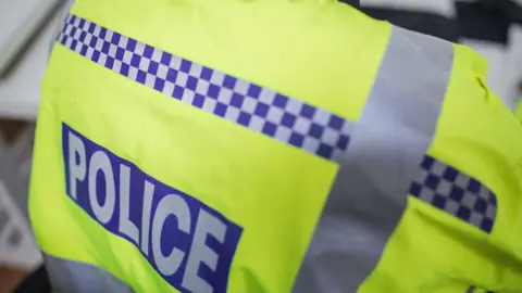A stock photo of a police officer's florescent jacket.